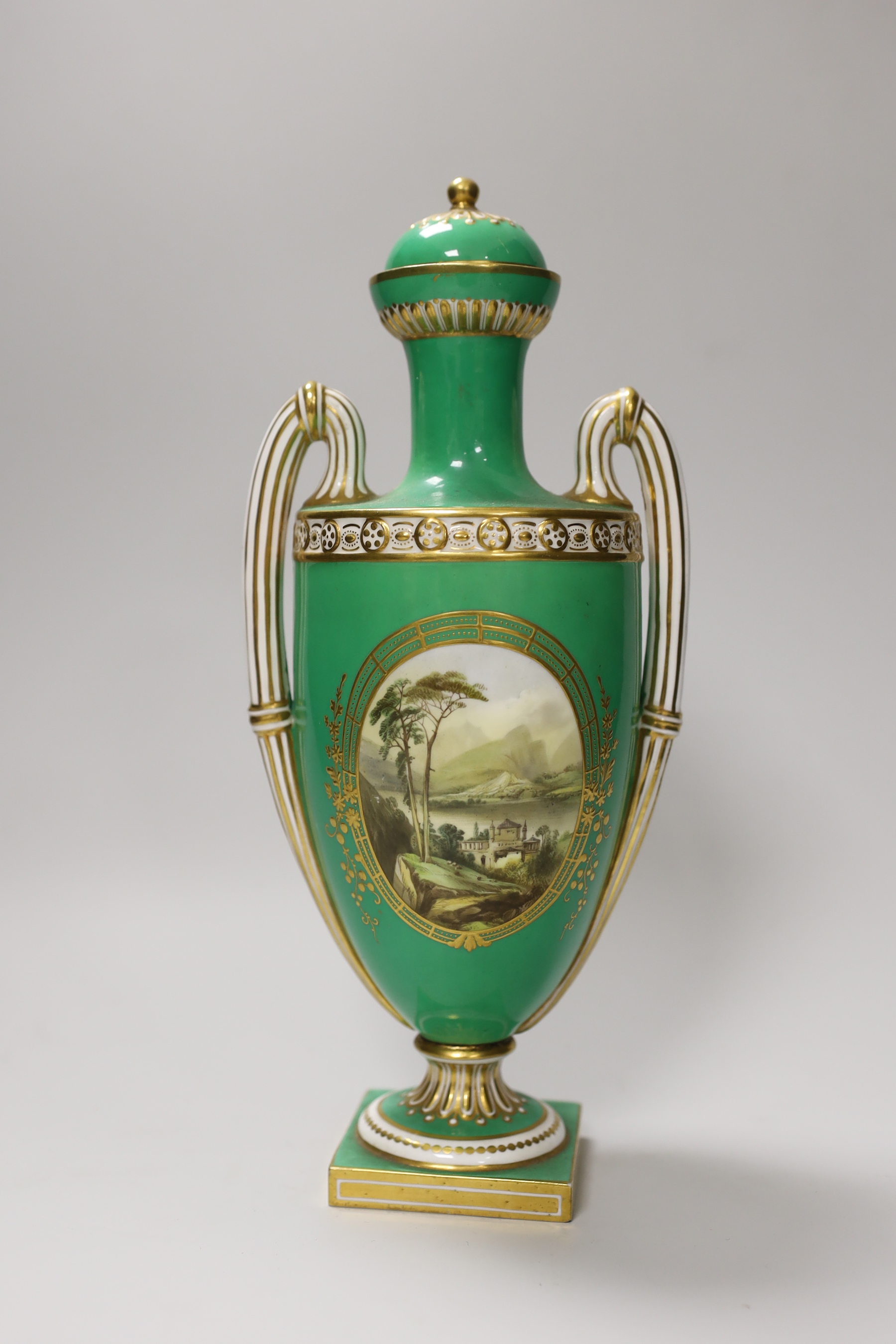 A Coalport two handled green ground vase and cover painted with a landscape, verso with fruit by Cook, 28cm high